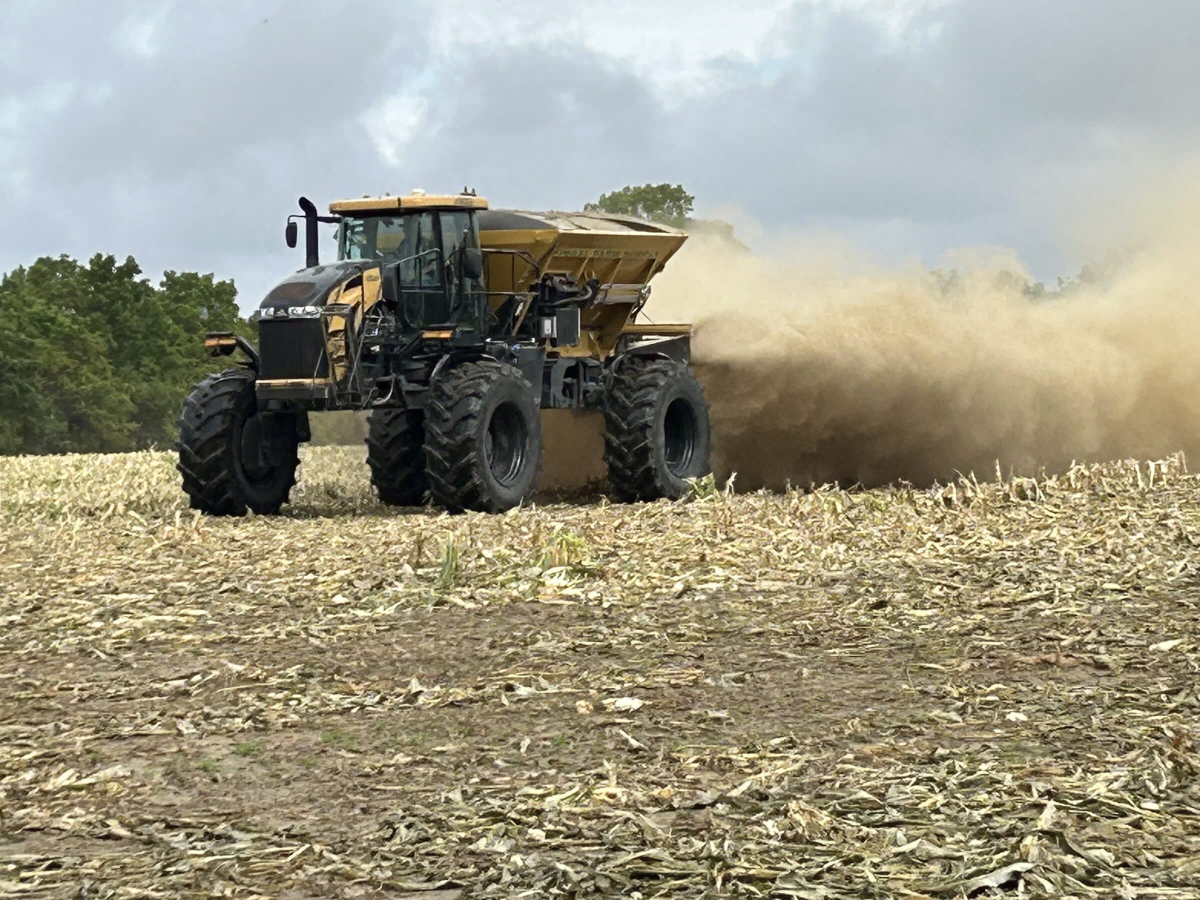 Floater spreader actively applying N-Rich fertilizer across harvested corn stubble